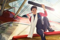 Woman wing-walking on a biplane
